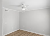 Thumbnail 34 of 45 - A room with a ceiling fan and light fixture.