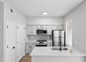 Thumbnail 32 of 45 - A kitchen with white cabinets and appliances.
