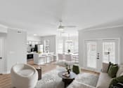 Thumbnail 40 of 45 - A modern living room with a grey sofa and a round chair.