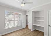 Thumbnail 33 of 45 - A room with a ceiling fan and a window with blinds.