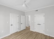 Thumbnail 37 of 45 - A room with a ceiling fan and three doors.
