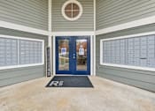 Thumbnail 30 of 45 - A blue door with a glass window is flanked by two mailboxes.