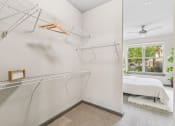 Thumbnail 13 of 19 - a bedroom with a white closet and a bed and a glass window