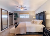 Thumbnail 29 of 29 - A bedroom with a large bed and a ceiling fan.