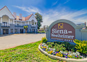Thumbnail 2 of 29 - A sign for Siena on Westheimer Apartment Homes is in front of a building.