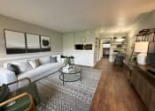 Thumbnail 4 of 29 - a living room with a couch and a table