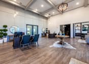 Thumbnail 27 of 32 - A modern living room with dark wood floors and furniture.