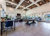 Thumbnail 25 of 32 - A spacious living room with a high ceiling and wooden beams.