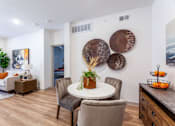 Thumbnail 4 of 32 - A dining room with a white table and chairs.