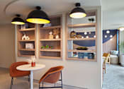 Thumbnail 22 of 27 - A modern dining area with a white table, chairs, and shelves with decorative items.
