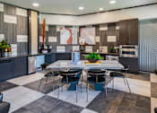 Thumbnail 14 of 29 - A modern kitchen with a dining table set for four.