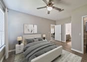 Thumbnail 8 of 29 - A bedroom with a bed, nightstands, and a ceiling fan.