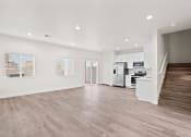 Thumbnail 1 of 24 - a living room with a staircase and a kitchen