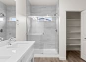 Thumbnail 8 of 24 - a white bathroom with a shower and a sink