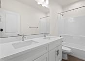 Thumbnail 16 of 24 - a bathroom with a sink and a toilet and a shower