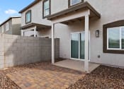 Thumbnail 17 of 24 - the front entrance of a house with a stone wall and a patio