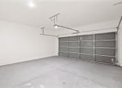 Thumbnail 19 of 24 - the interior of a garage with a metal door