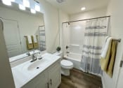 Thumbnail 10 of 46 - a bathroom with a sink and a toilet and a shower