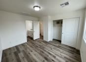Thumbnail 8 of 46 - an empty living room with white walls and wood flooring