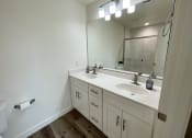 Thumbnail 27 of 46 - an empty bathroom with a sink and a mirror