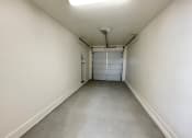 Thumbnail 21 of 46 - a large empty room with white walls and a gray floor
