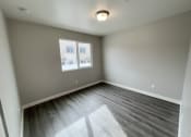 Thumbnail 38 of 46 - an empty living room with gray walls and a window