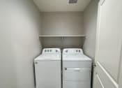 Thumbnail 46 of 46 - an empty laundry room with two washes and a dryer