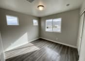 Thumbnail 45 of 46 - an empty living room with wood floors and a window