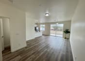 Thumbnail 30 of 46 - an empty living room with hardwood flooring and a window