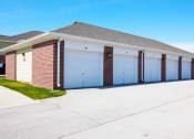Thumbnail 15 of 15 - a garage with three white garage doors on the side of a house