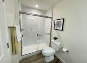 Thumbnail 33 of 46 - a small bathroom with a shower and a toilet