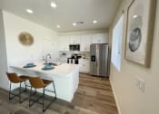 Thumbnail 42 of 46 - an open kitchen and dining area with a stainless steel refrigerator