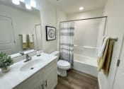 Thumbnail 31 of 46 - the residence on lamar apartment bathroom with shower sink and toilet