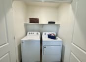 Thumbnail 32 of 46 - a small laundry room with a washer and dryer