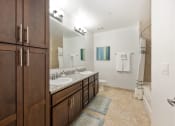 Thumbnail 33 of 44 - a bathroom with two sinks and a mirror and a shower