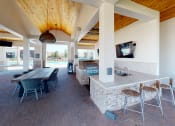 Thumbnail 24 of 33 - a kitchen and dining area with a television and a pool in the background