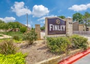 Thumbnail 1 of 26 - a sign that says finley athletic center with a building and trees in the background
