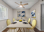 Thumbnail 3 of 30 - A dining room with a white table and yellow chairs.