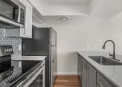 Thumbnail 9 of 30 - the preserve at ballantyne commons apartment kitchen with stainless steel appliances