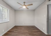 Thumbnail 17 of 30 - an empty room with a ceiling fan and a window