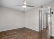 Thumbnail 18 of 30 - the spacious living room with white walls and a ceiling fan