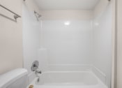 Thumbnail 21 of 30 - a white bathroom with a tub and a toilet and a sink