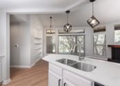 Thumbnail 25 of 33 - a kitchen with a sink and a window