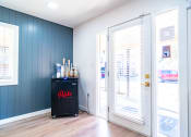 Thumbnail 41 of 44 - a bar in the corner of a room with blue walls and a glass door