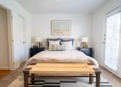 Thumbnail 14 of 44 - a bedroom with a bed and a coffee table