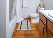 Thumbnail 16 of 44 - a bathroom with a toilet and a shower and a sink
