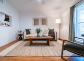 Thumbnail 6 of 44 - a living room with a couch and a coffee table
