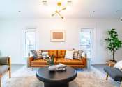 Thumbnail 3 of 44 - a living room with a brown couch and a coffee table