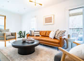 Thumbnail 2 of 44 - a living room with a leather couch and a coffee table