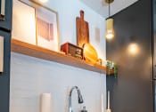 Thumbnail 39 of 44 - a kitchen with black cabinets and white counter top and a sink